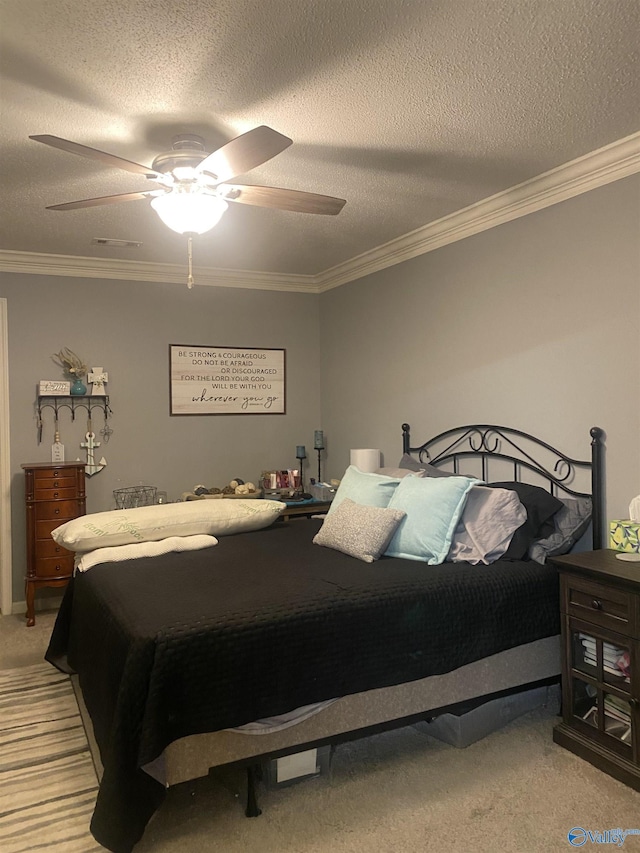 bedroom featuring ornamental molding, light colored carpet, ceiling fan, and a textured ceiling