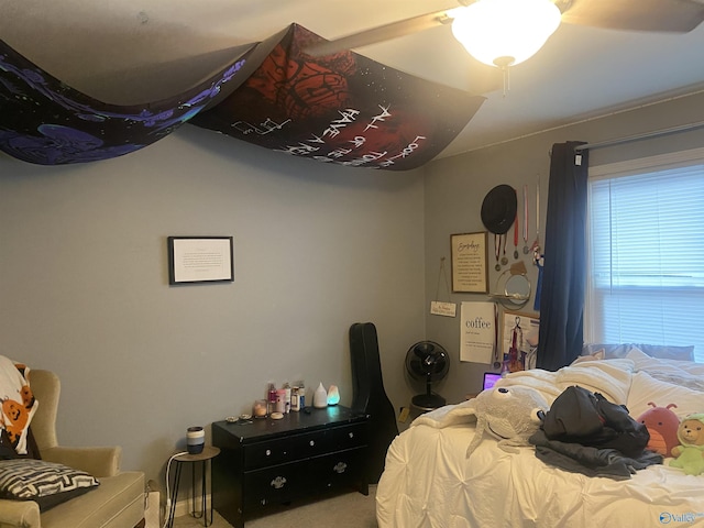 bedroom featuring ceiling fan and carpet