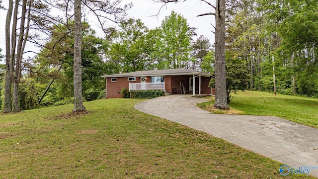 451 County Road 208, Bridgeport, AL 35740 - single story home with driveway, a front lawn, brick siding, and covered porch