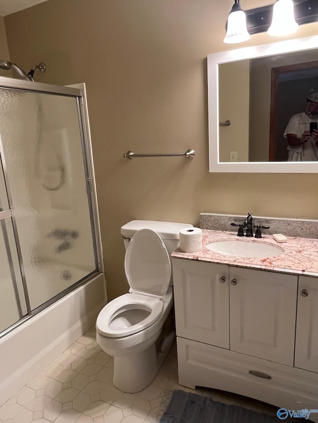 136 Atnip Dr, Scottsboro, AL 35769 - bathroom with vanity, tile patterned flooring, toilet, and shower / bath combination with glass door