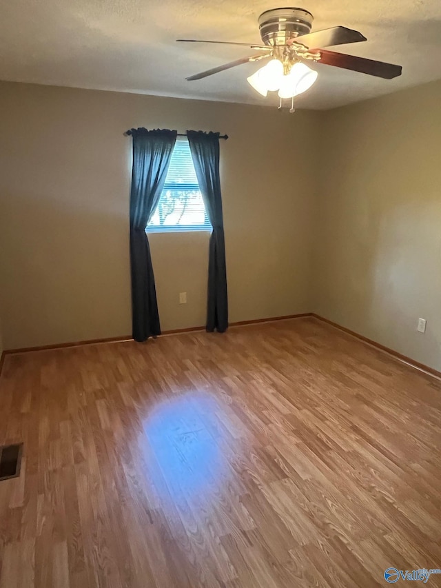 136 Atnip Dr, Scottsboro, AL 35769 - empty room featuring wood finished floors, a ceiling fan, and baseboards