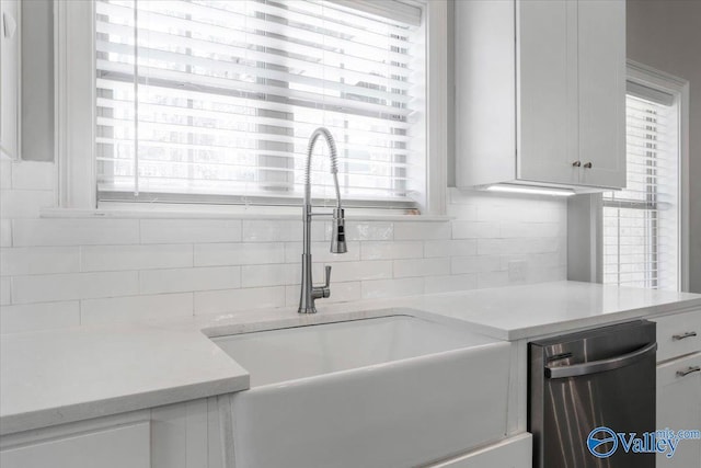 kitchen featuring sink, white cabinets, and a healthy amount of sunlight