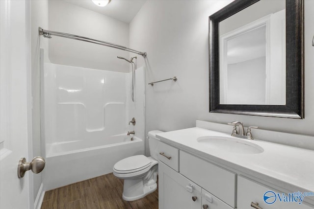 full bathroom with wood-type flooring, vanity, shower / bath combination, and toilet