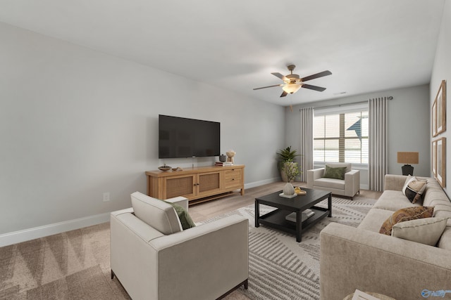 carpeted living room featuring ceiling fan