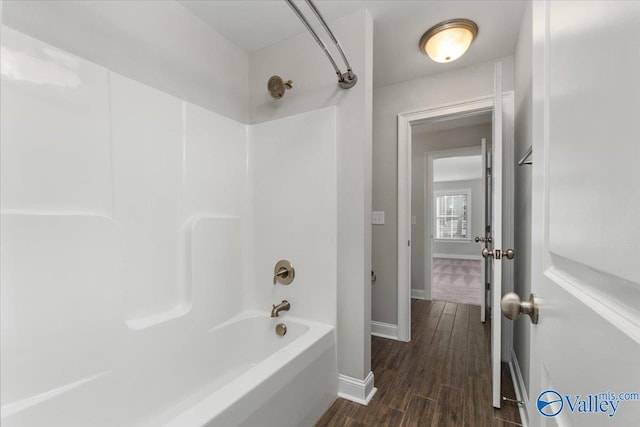 bathroom with shower / bathing tub combination and hardwood / wood-style floors