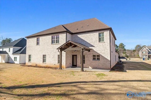 view of front of home with a patio area and a front yard