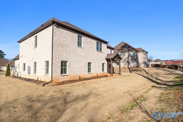 rear view of house with a yard