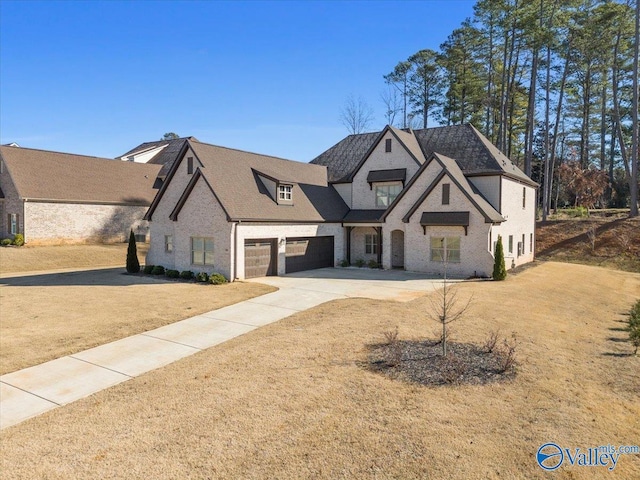 view of front of home with a garage and a front lawn