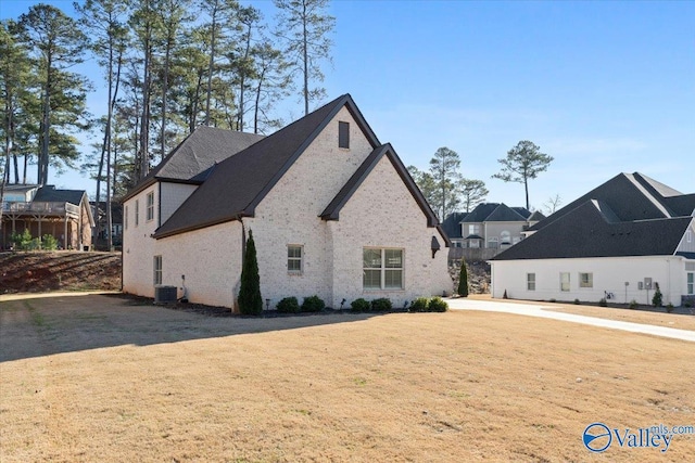 exterior space featuring a yard and central AC