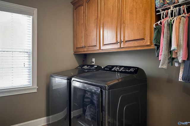 washroom featuring cabinets and independent washer and dryer
