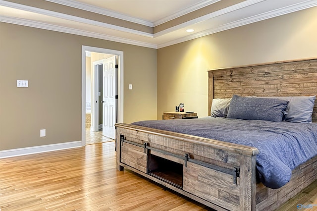 bedroom with crown molding, light hardwood / wood-style floors, and a raised ceiling