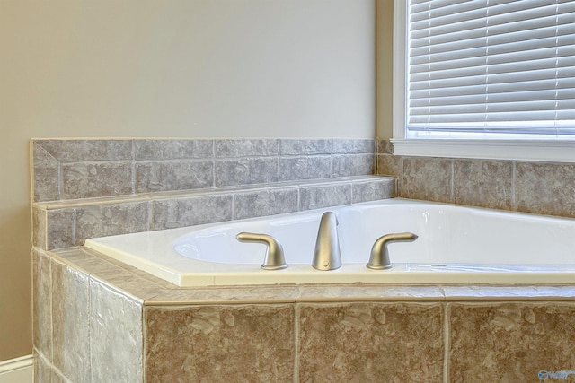bathroom with a relaxing tiled tub