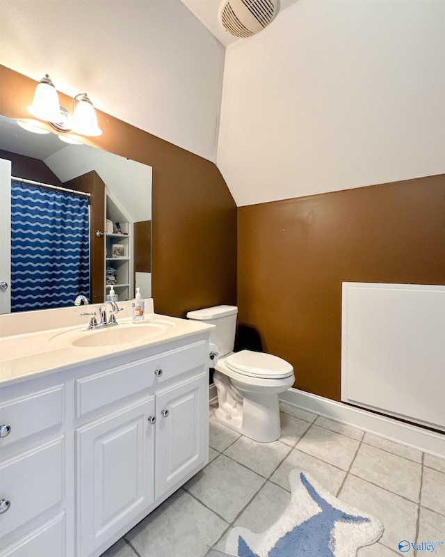 bathroom with vanity, toilet, tile patterned floors, and lofted ceiling