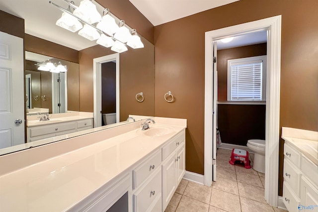 bathroom featuring tile patterned floors, vanity, and toilet