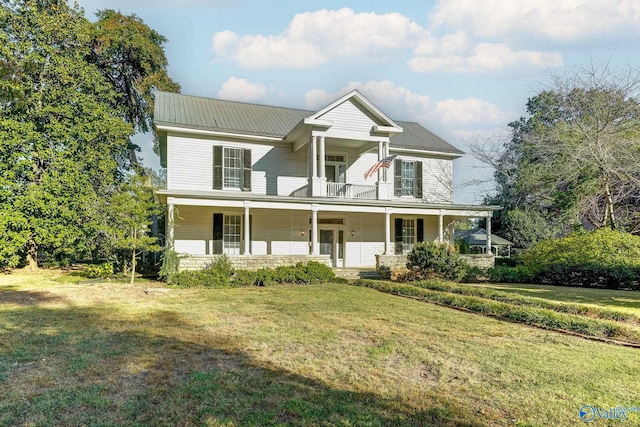 view of front facade featuring a porch, a balcony, and a front yard