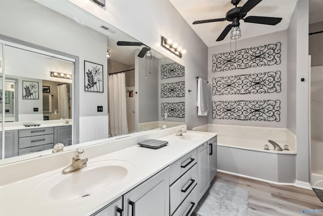 15037 SE Ashmont Blvd, Huntsville, AL 35803 - full bathroom with a bath, a ceiling fan, wood finished floors, double vanity, and a shower with shower curtain