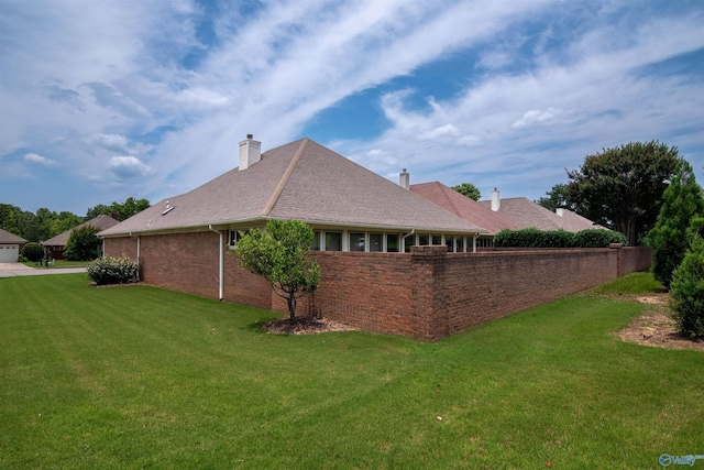 15037 SE Ashmont Blvd, Huntsville, AL 35803 - view of side of property featuring a yard, brick siding, and a chimney