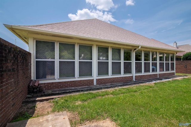 15037 SE Ashmont Blvd, Huntsville, AL 35803 - rear view of house with brick siding, roof with shingles, a sunroom, and a yard