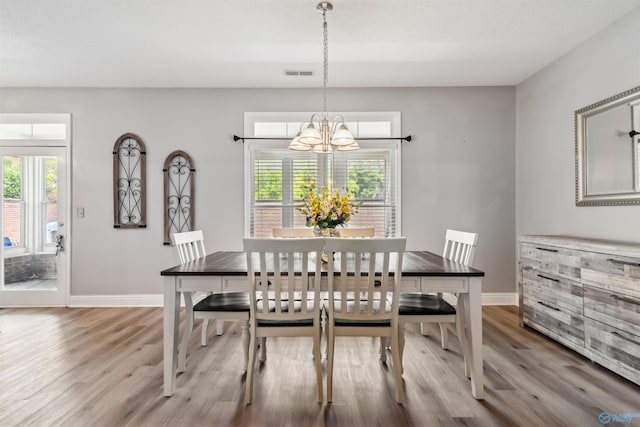 15037 SE Ashmont Blvd, Huntsville, AL 35803 - dining room with a chandelier and wood finished floors