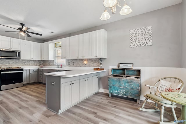 15037 SE Ashmont Blvd, Huntsville, AL 35803 - kitchen with stainless steel appliances, gray cabinetry, a peninsula, and decorative backsplash