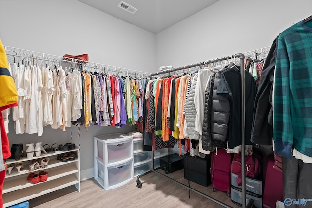 spacious closet featuring visible vents and wood finished floors