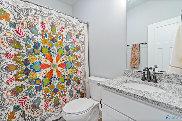 bathroom with visible vents, curtained shower, toilet, and vanity