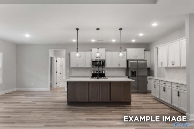kitchen with stainless steel appliances, recessed lighting, light countertops, and a sink