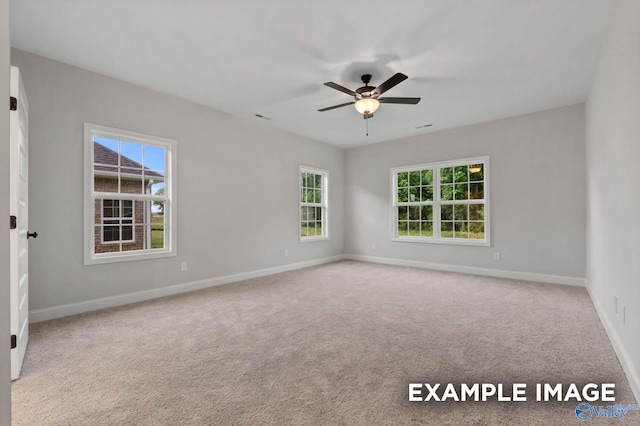 unfurnished room featuring plenty of natural light, baseboards, a ceiling fan, and carpet floors