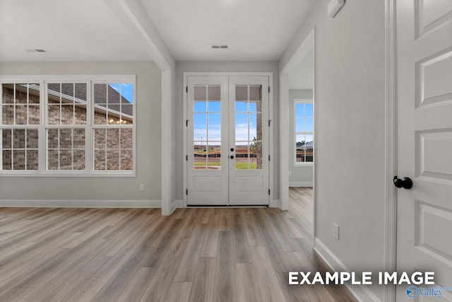 entryway with french doors, baseboards, visible vents, and wood finished floors
