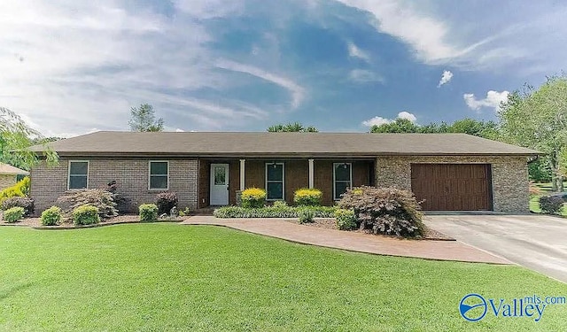 ranch-style house featuring a front yard and a garage