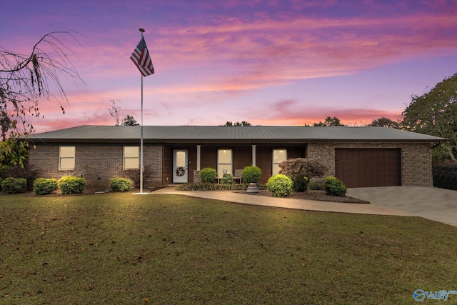 1707 Byron Rd, Scottsboro, AL 35769 - ranch-style house with a garage, concrete driveway, a front lawn, and brick siding