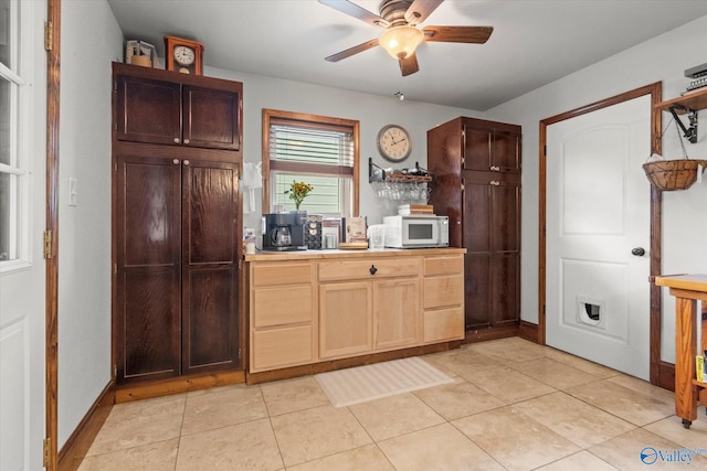 1707 Byron Rd, Scottsboro, AL 35769 - kitchen with white microwave, a ceiling fan, light tile patterned flooring, and tile counters