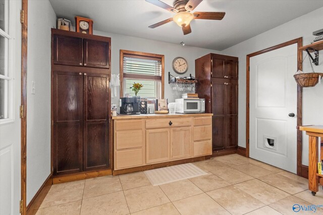 kitchen with light tile patterned flooring and ceiling fan