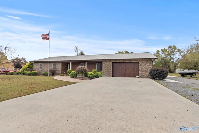 ranch-style home featuring a front yard and a garage