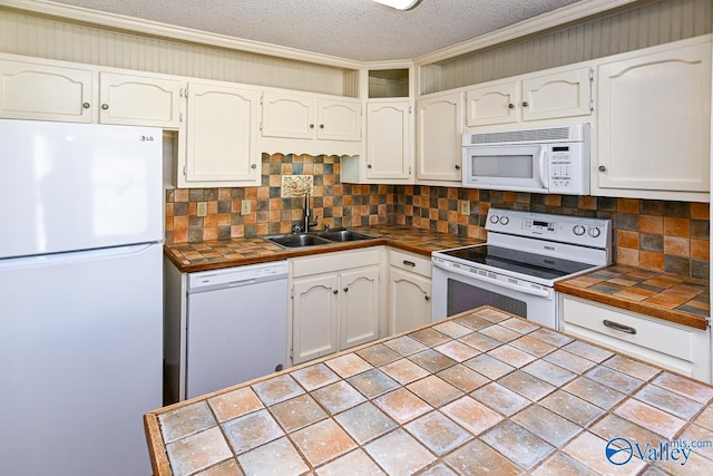 kitchen featuring a textured ceiling, white appliances, sink, tile countertops, and white cabinets