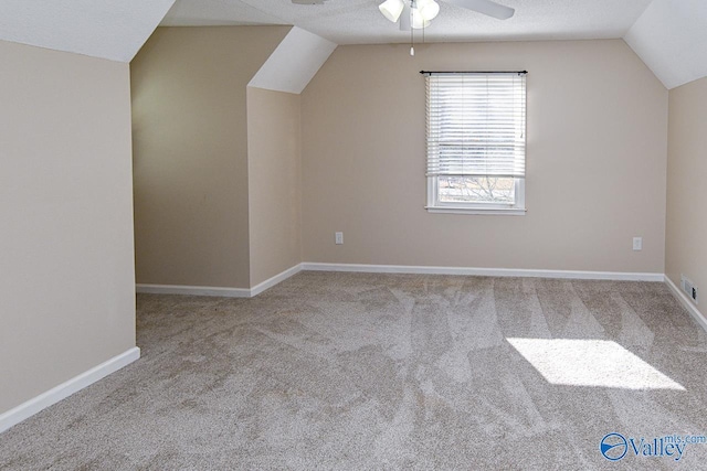 bonus room with light carpet, a textured ceiling, and lofted ceiling