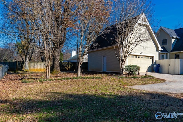 view of home's exterior featuring a yard and a garage