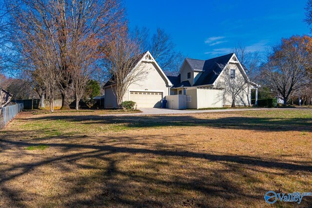 view of front of property featuring a front lawn and a garage