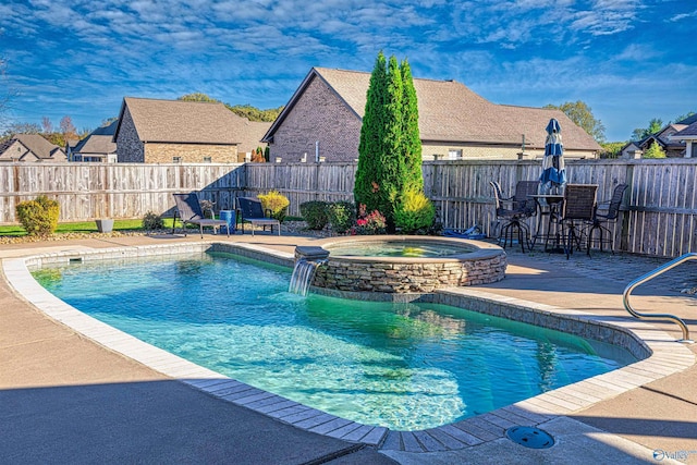 view of pool with pool water feature, a patio area, and an in ground hot tub