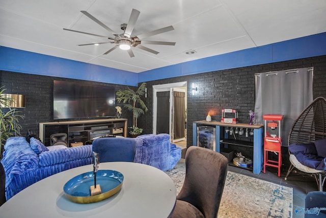 dining area with beverage cooler, ceiling fan, tile patterned flooring, and brick wall