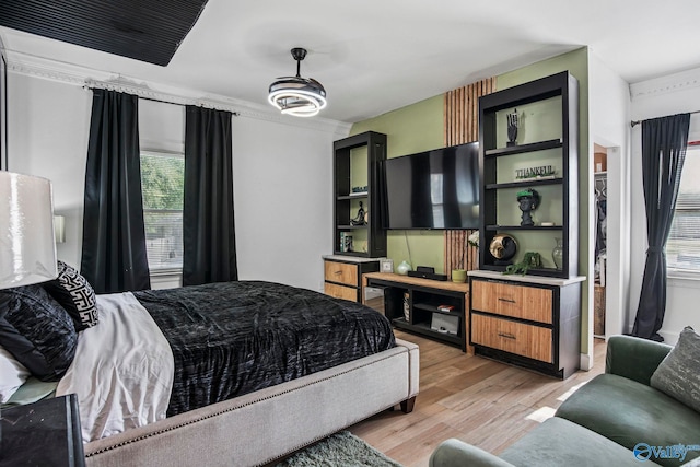 bedroom featuring light wood-style flooring and multiple windows