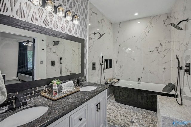 bathroom featuring ceiling fan, a sink, a marble finish shower, and a soaking tub