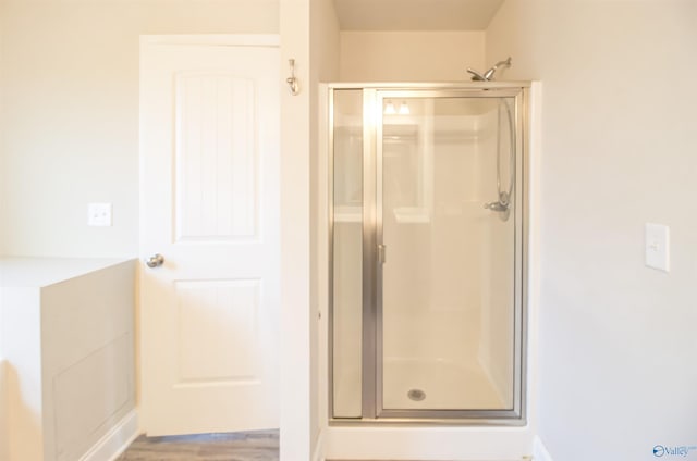 bathroom featuring a shower with shower door