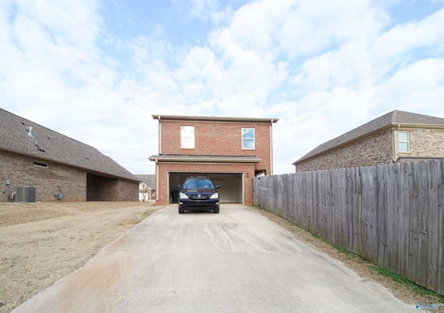 exterior space featuring cooling unit and a garage