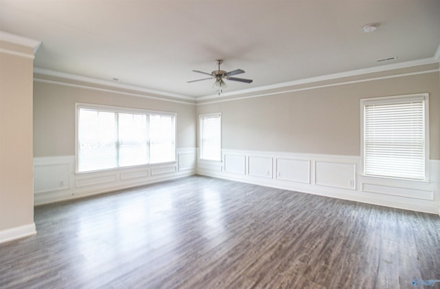 spare room featuring dark wood-type flooring, ornamental molding, and ceiling fan