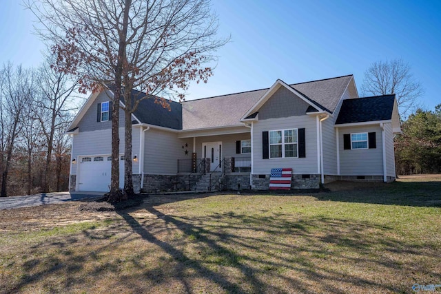 view of front of house with an attached garage, a porch, roof with shingles, and a front yard