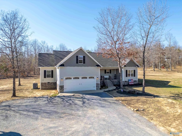 view of front of property with aphalt driveway, a front yard, stone siding, and cooling unit