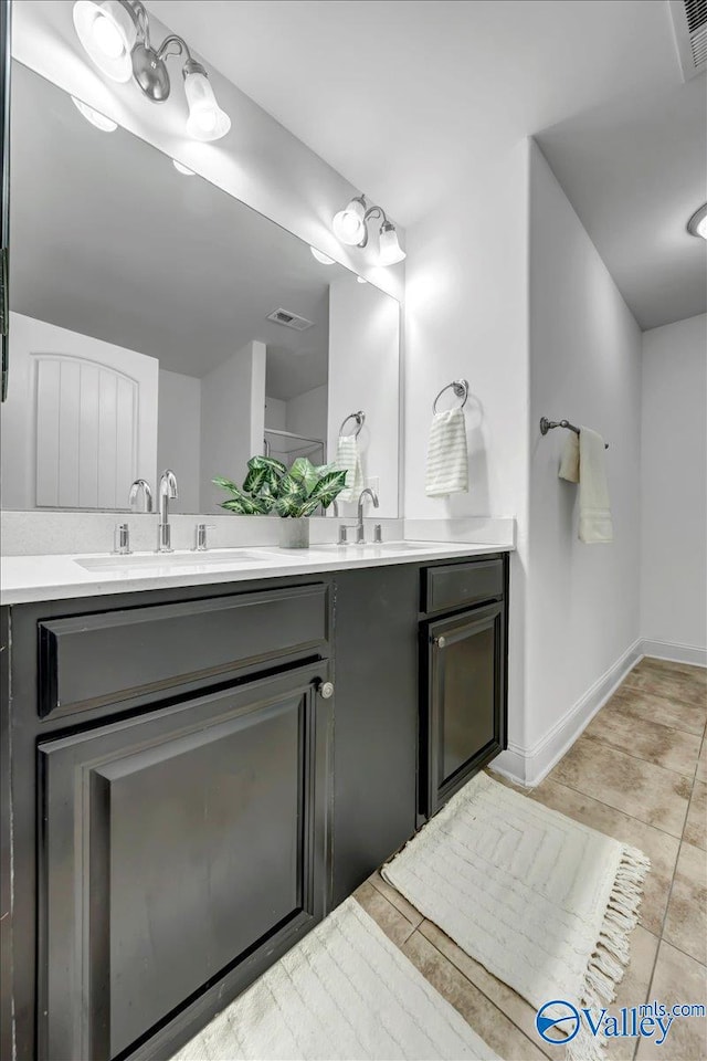 bathroom with tile patterned floors and vanity