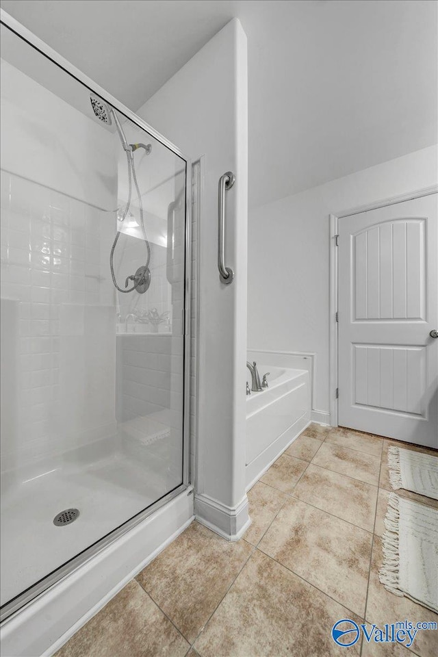 bathroom featuring tile patterned flooring and shower with separate bathtub