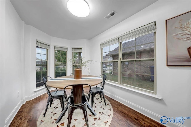 dining room with dark hardwood / wood-style floors